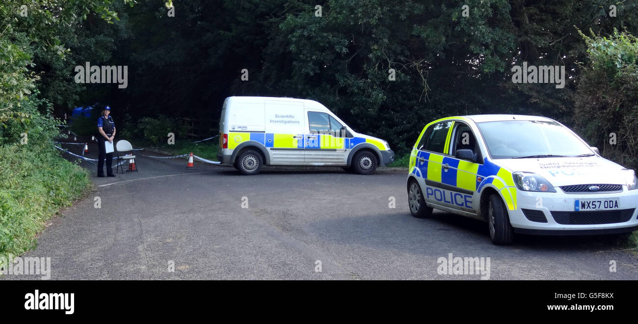 Police at the scene in a lane in Ashill off the A358 near Ilminster, Somerset, after a young woman was discovered dead in a burning car. Stock Photo