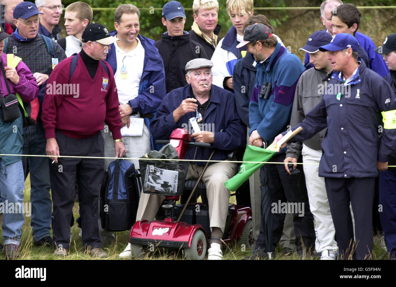 A spectator laughs after America's Tiger Woods ball hits his motorised
