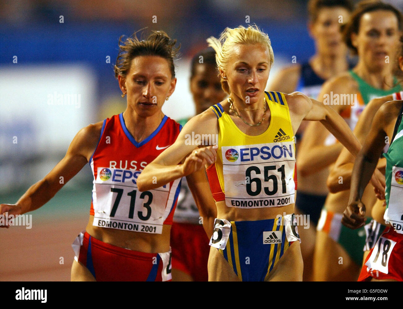 Romanian Gabriela Szabo (R) and Russian Olga Yegorova collide during their heat of the women's 5000m at the IAAF World Championships in Edmonton, Canada. Stock Photo