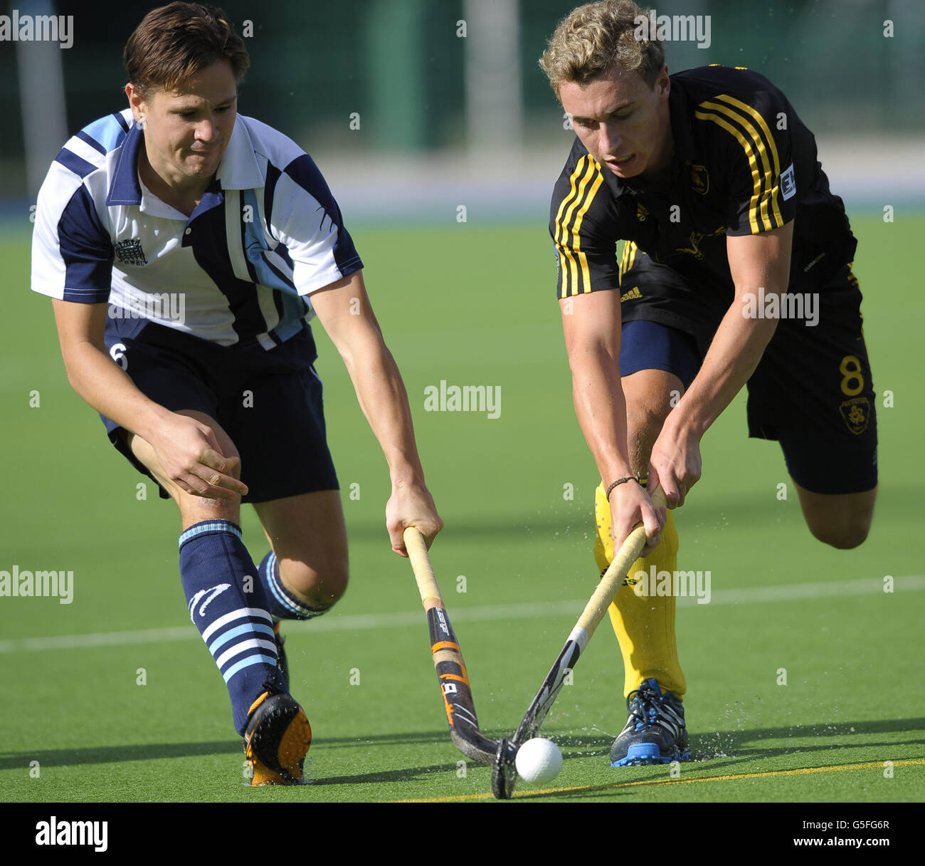 Beeston's Harry Martin (R) is challenged by Hampstead and Westminster's Iain Mackay during their Men's Hockey League Premier Division game at the Paddington Recreation Ground, London. Stock Photo