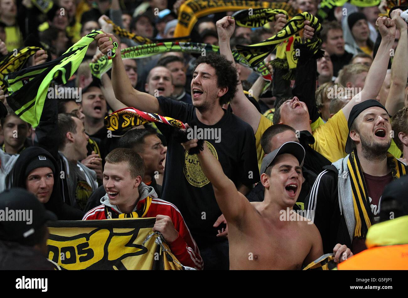 Borussia Dortmund fans in celebratory mood in the stands Stock Photo