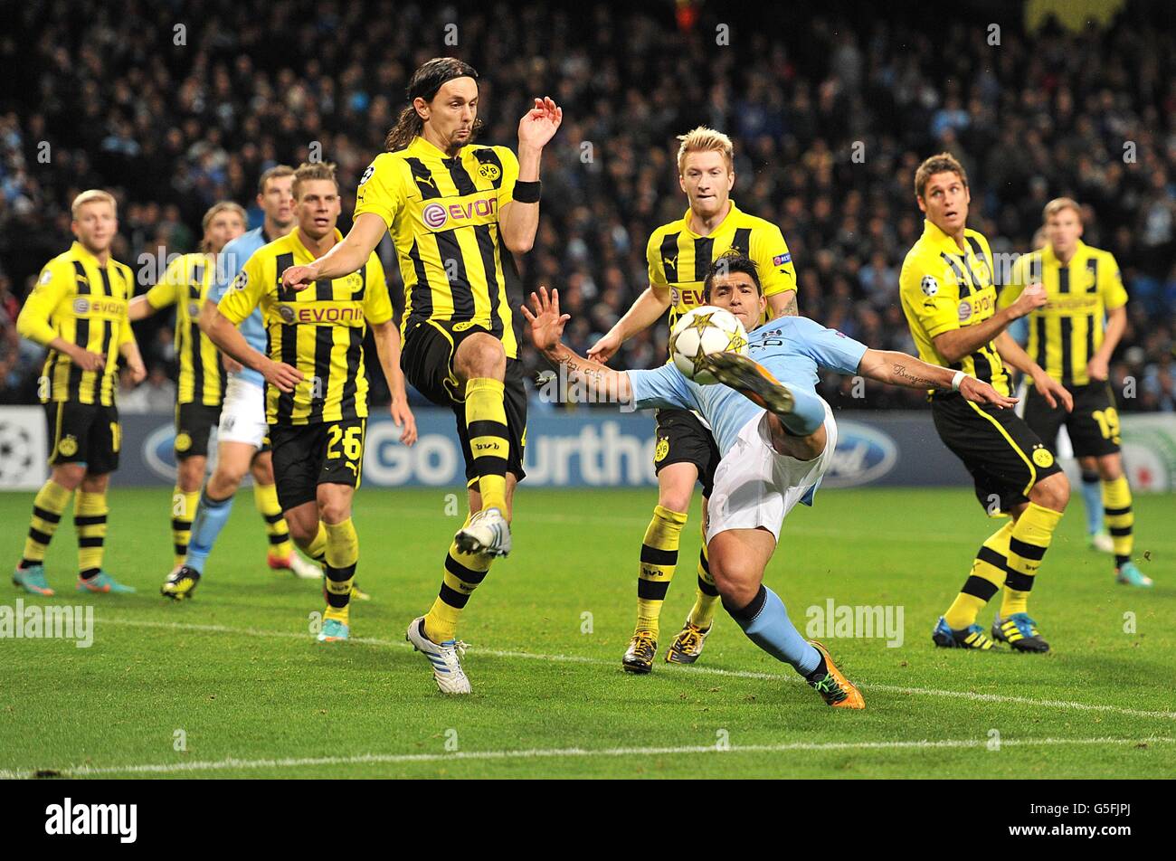 Manchester City's Sergio Aguero has a shot blocked by the hand of Borussia Dortmund's Neven Subotic (centre left) to concede a penalty, scored by Mario Balotelli Stock Photo