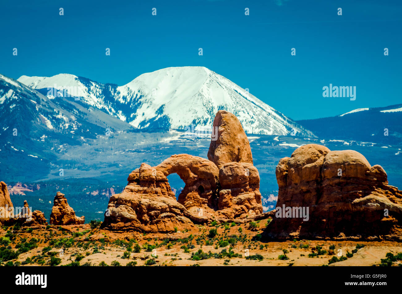 Snowy mountain in the background from Arches National Park in wonderful Utah, during spring. Stock Photo
