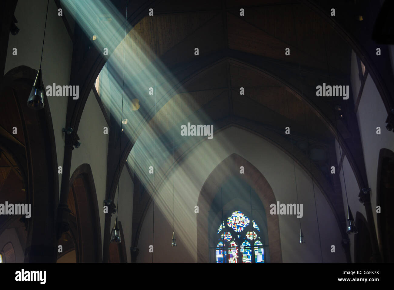 light shafts stream into church window Stock Photo
