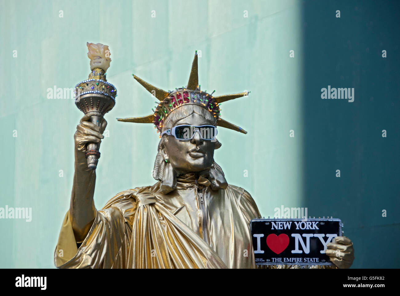 A Statue if Liberty Character busker in Times Square holding an I LOVE NEW YORK sign. Stock Photo