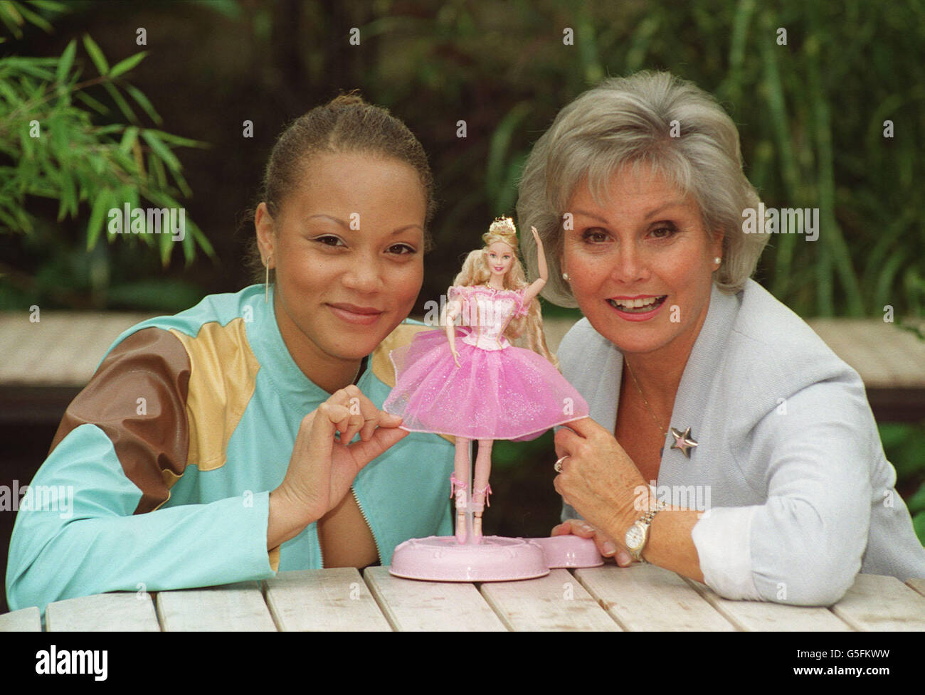 Actress Angela Griffin (left) and Chairman of English National Ballet, Angela Rippon pose with a Barbie doll in London, when it was announced that the National Ballet has signed a sponsorship deal with US toy company Mattel, to stage Tchaikovsky's The Nutcracker. * The six week run at the Coliseum Theatre in London is designed to coincide with the launch of Barbie's first animated feature film on 29 October, in which the famous doll is seen performing the famous ballet. See PA story ARTS Barbie. PA Photo: Johnny Green. Stock Photo