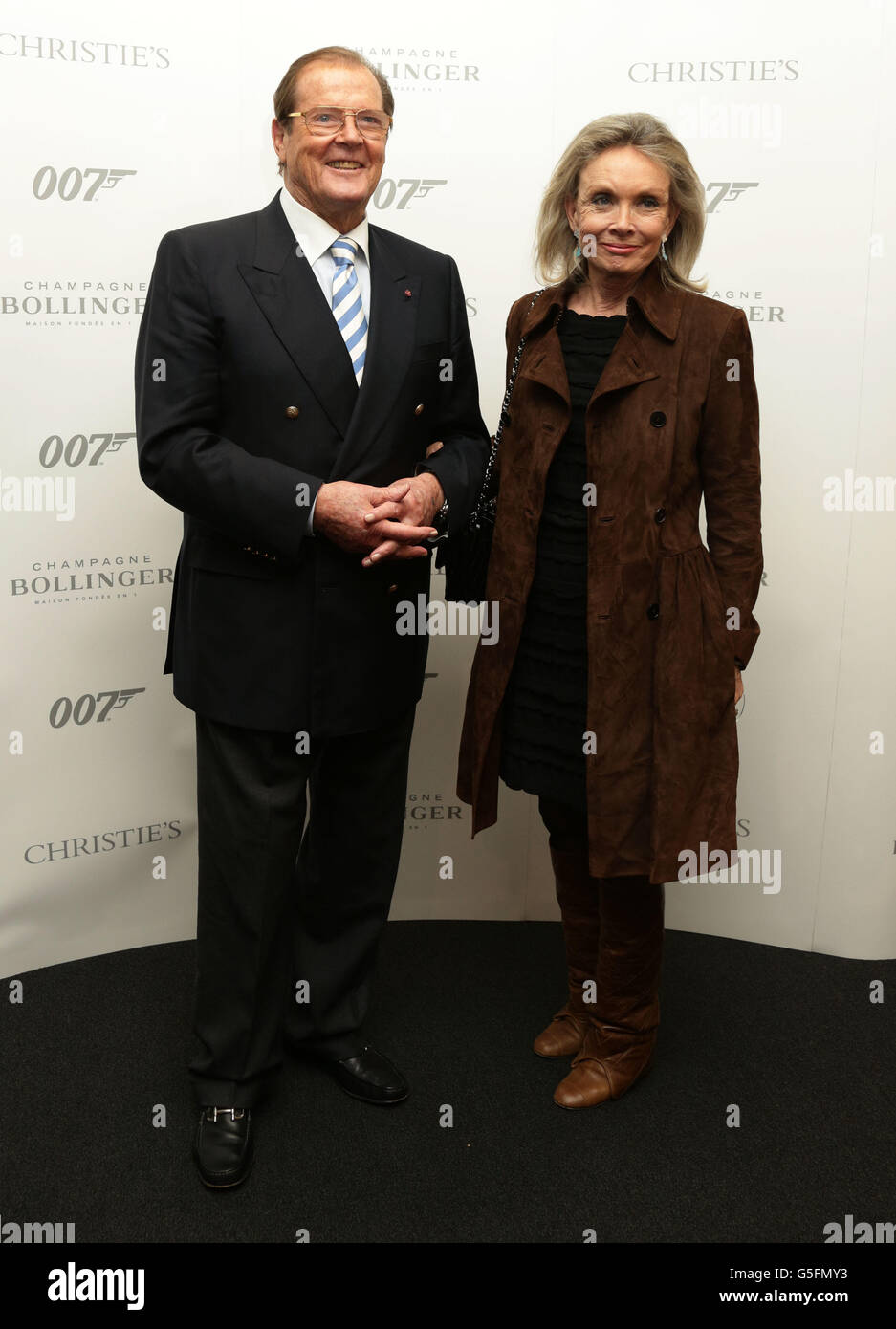 Sir Roger Moore and his wife Kristina Tholstrup attending Christie's 50 Years of James Bond Sale, featuring memorabilia donated from the Bond cast, at Christie's in South Kensington, London. Stock Photo