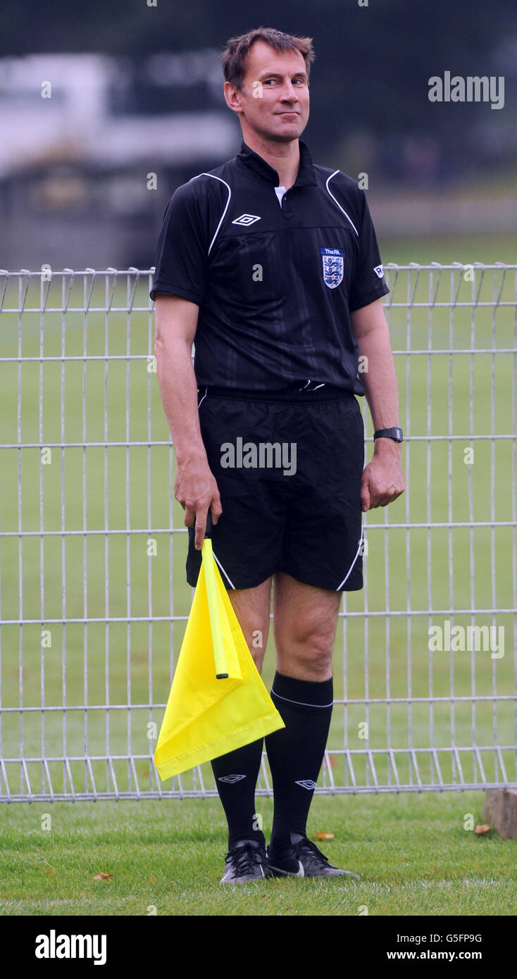 Health Secretary Jeremy Hunt acts as linesman during a football match between Conservative MPs and the press in Birmingham today during the Tory party conference. Stock Photo