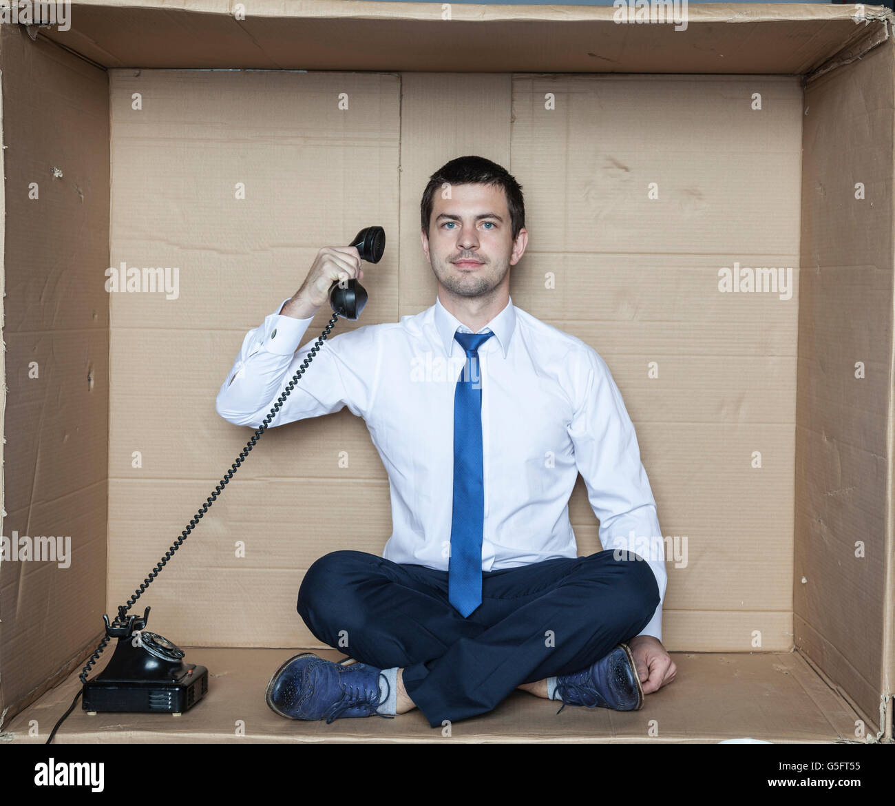 businessman hidden in a box eavesdropping phone calls Stock Photo Alamy