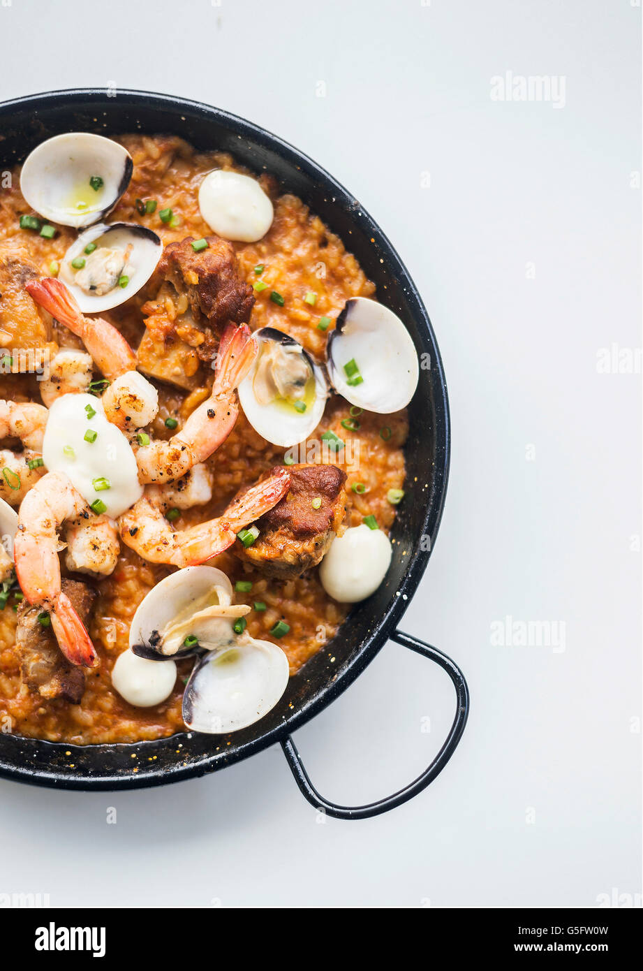 gourmet spanish seafood and rice paella risotto on white background Stock Photo