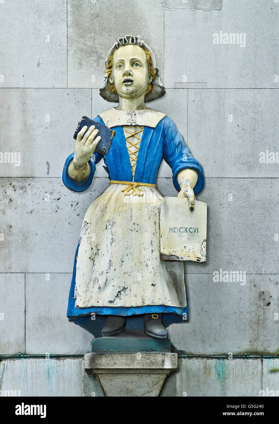 St Andrew's Holborn: blue coat orphan girl  wearing blue coat and holding Bible Stock Photo