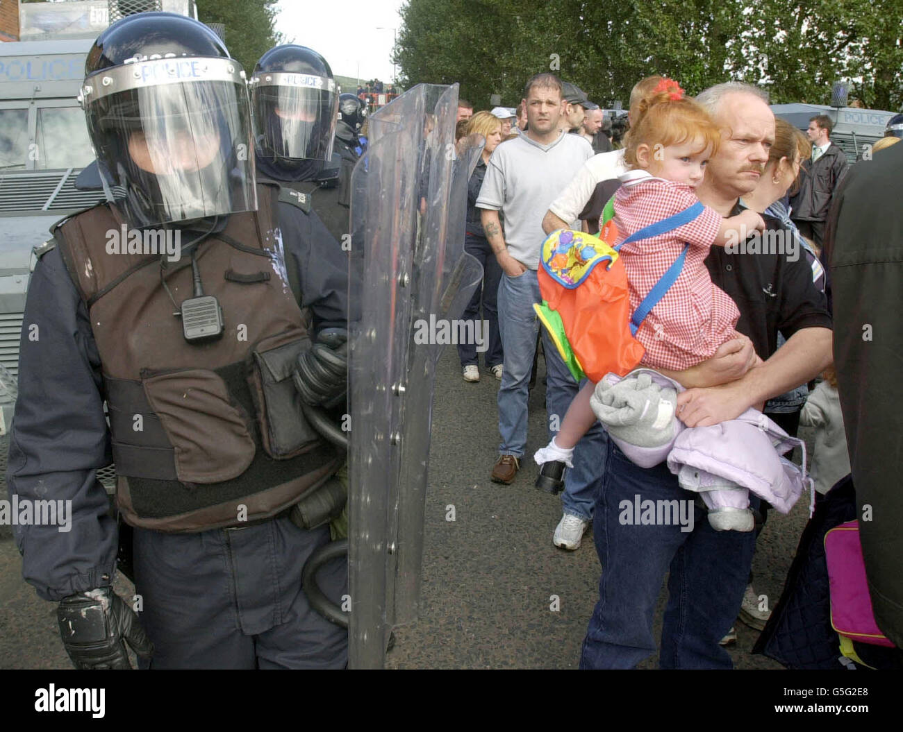 RUC officers form a safe corridor along the Ardoyne Road for parents to ...
