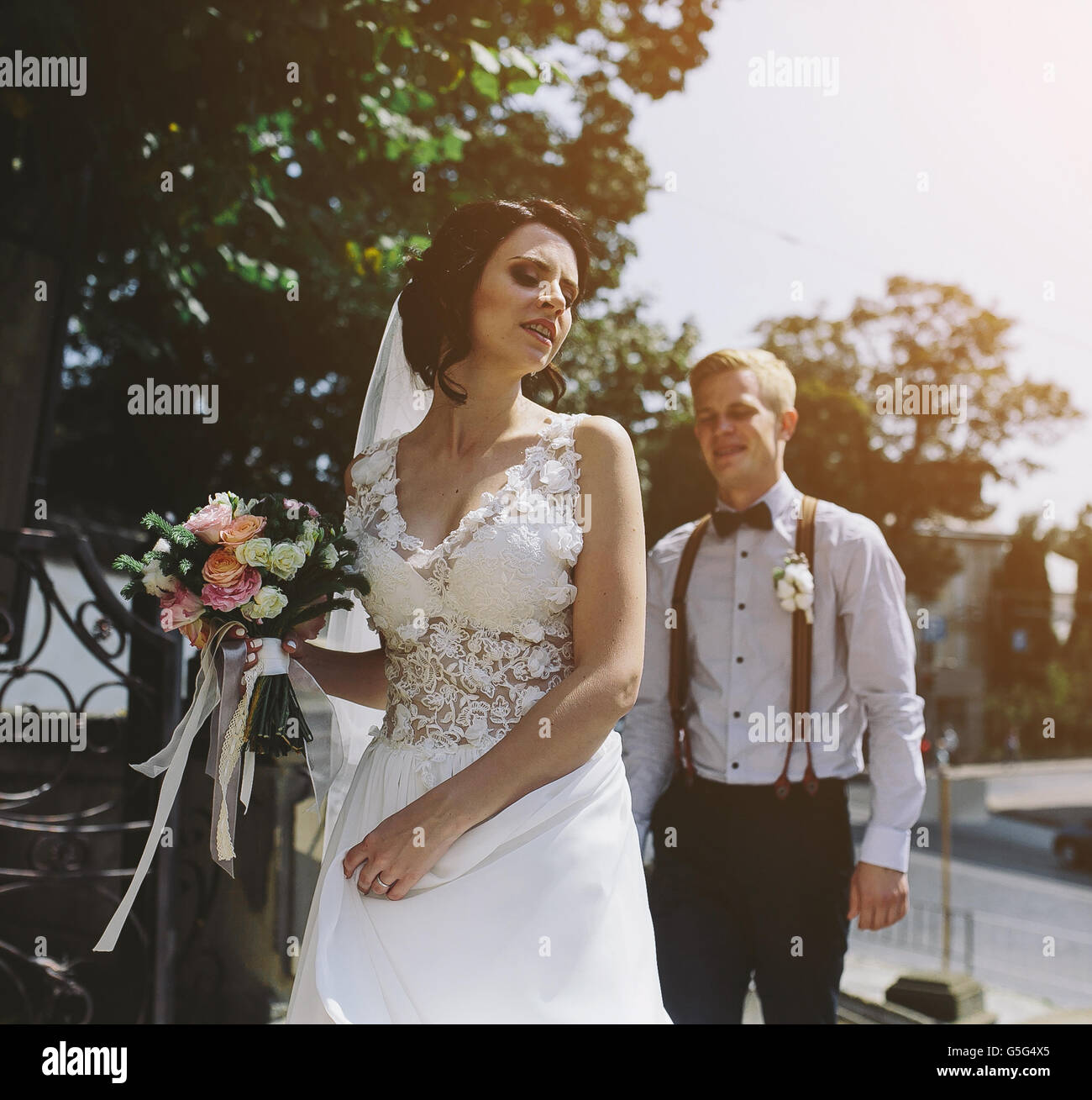 bride and groom posing on the streets Stock Photo - Alamy