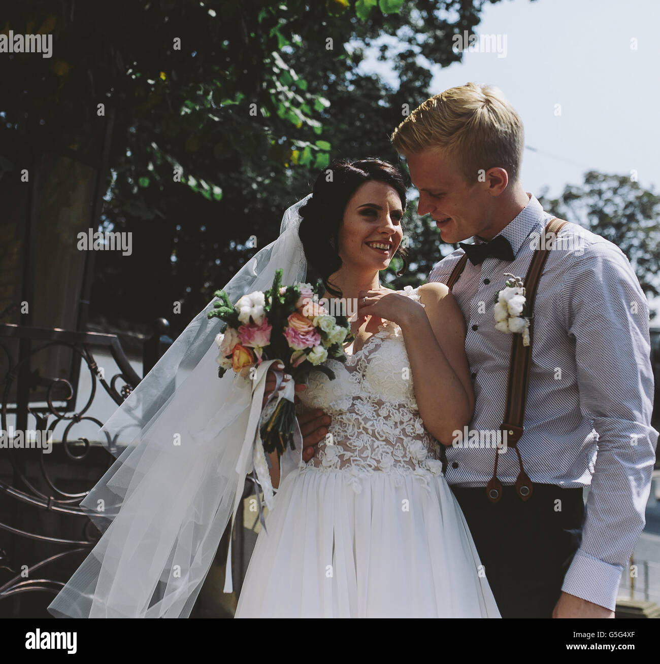 bride and groom posing on the streets Stock Photo - Alamy