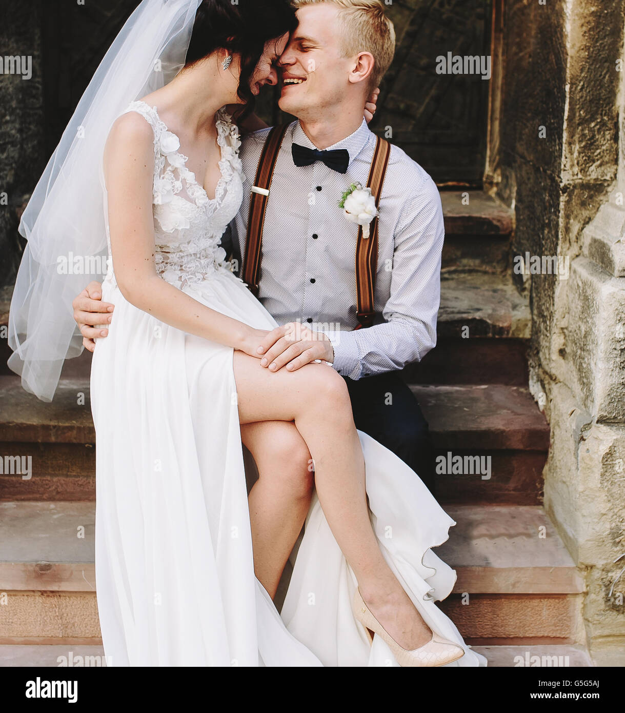 Bride sitting on lap of the groom Stock Photo - Alamy