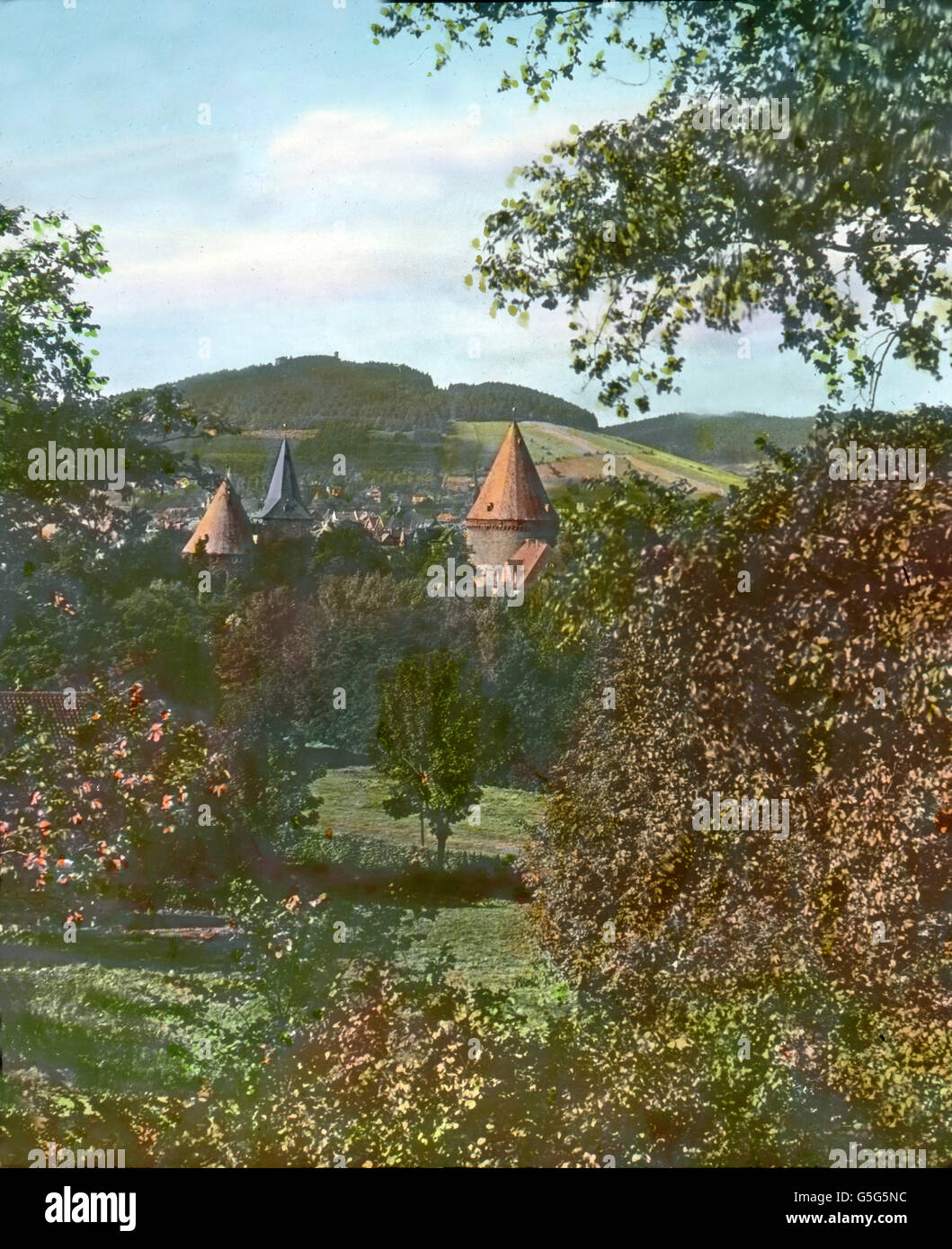 Ein Blick auf die Stadt Goslar. The city of Goslar in the Harz region. Europe, Germany, landscape, mountain range, history, historical, 1910s, 1920s, 20th century, archive, Carl Simon, sprijngtime, panorama, city, town, tower, medieval, trees, hand coloured glass slide Stock Photo