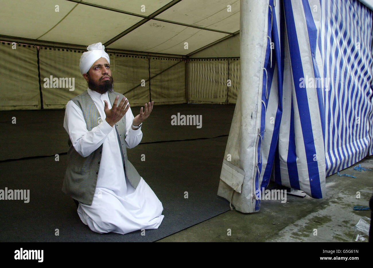 Hafiz Abdul Ghafoor, the Imam of the mosque in Annandale Street, Edinburgh, in a marquee close the mosque which was fire-bombed earlier this week, conducting prayers. * ..... The blaze was discovered at the building run by the Pakistani Association in Annandale Street, Leith by a member of the public who alerted police and the fire brigade. Stock Photo