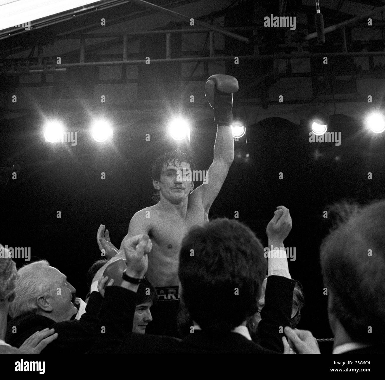Boxer Barry McGuigan, centre, celebrates after beating champion Eusebio