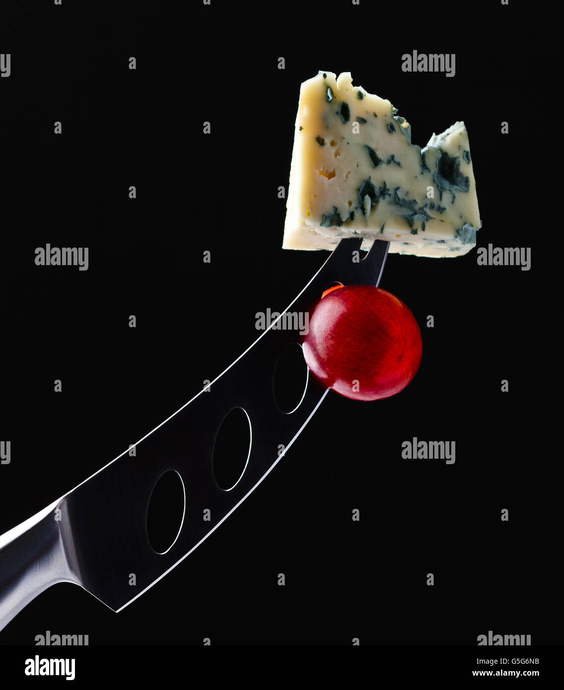 cheese and knife on a black background Stock Photo Alamy