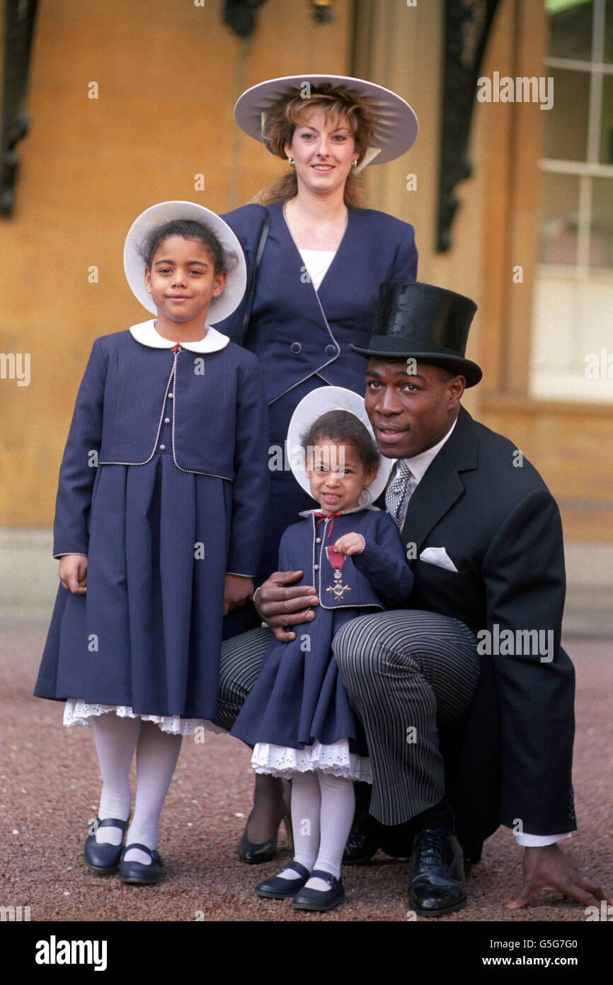 Heavyweight boxer Frank Bruno after receiving his MBE from the Prince of Wales at Buckingham Palace. The boxer is pictured with his wife Laura and daughters Nicola (left), age 7, and Rachel age 3. Stock Photo