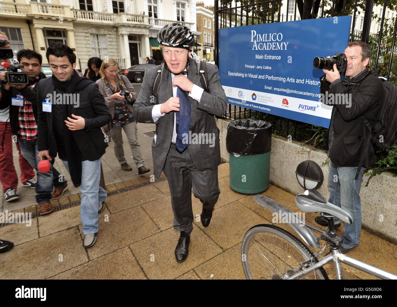 The Mayor of London Boris Johnson arrives on his bike at the Pimlico Academy in central London, where he revealed plans to make London a World leader in education. Stock Photo