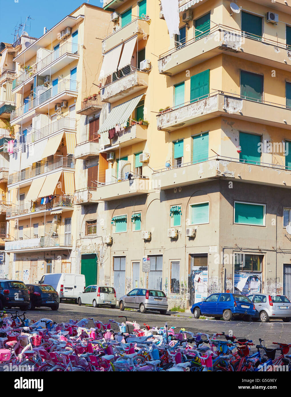 Children's bicycles for sale outside typical apartments Naples Campania Italy Europe Stock Photo