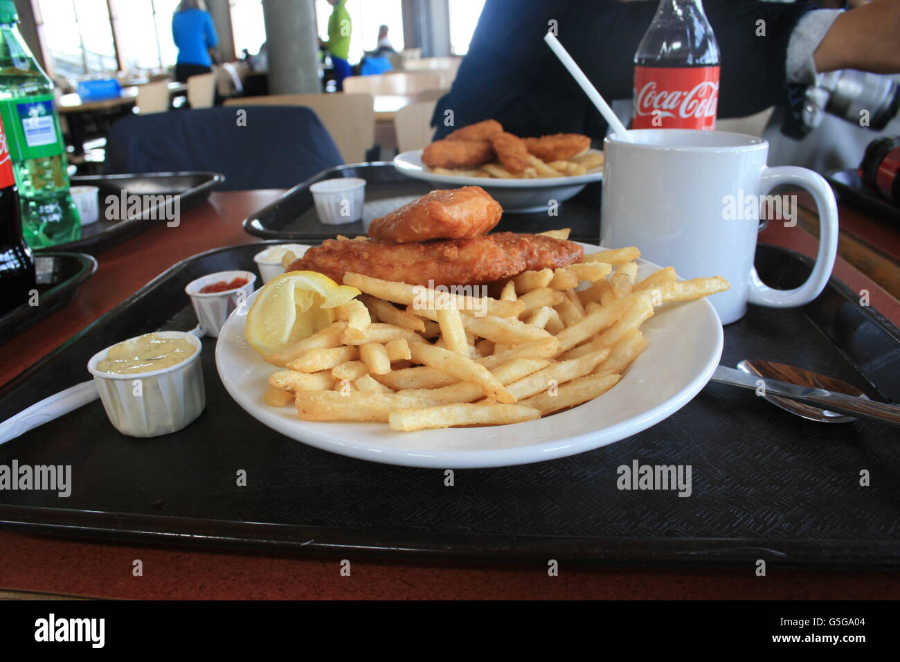 Fish and Chips with lemon, ketchup sauce, chocolate, and Coke with