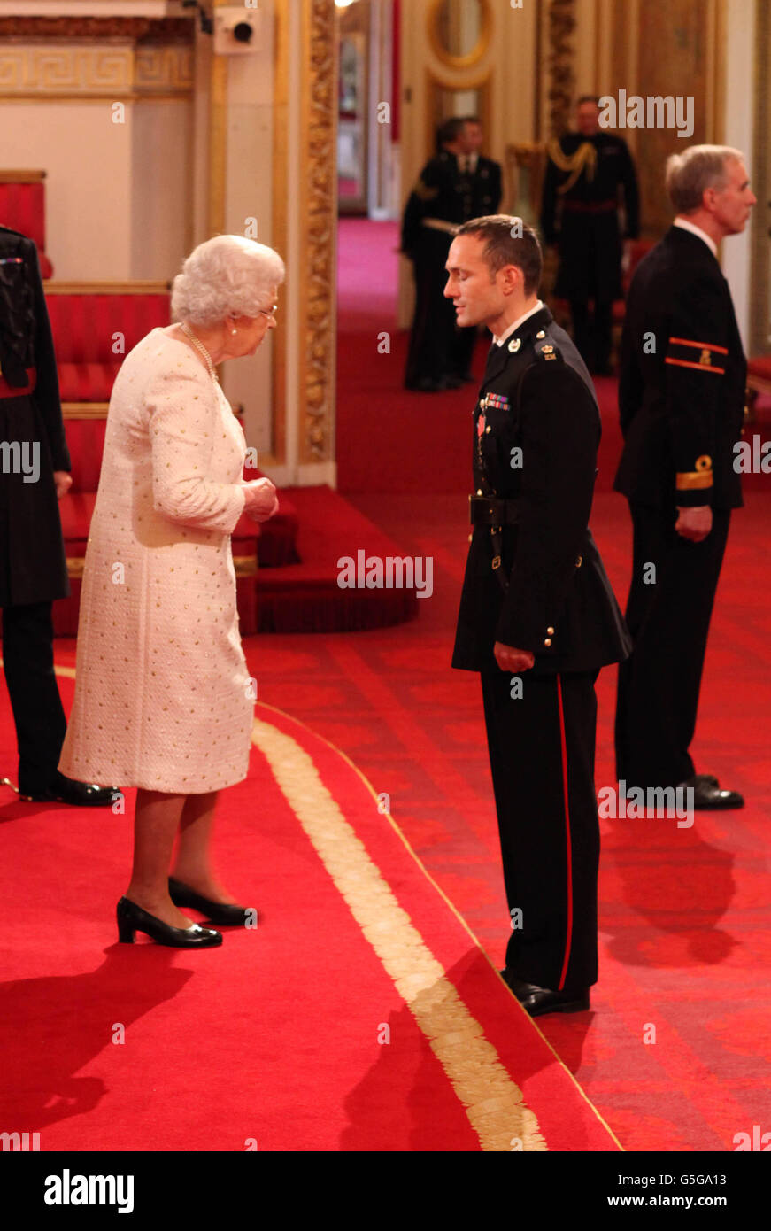 Major Niki Cavill, Royal Marines, is made an MBE, for services in  Afghanistan, by Queen Elizabeth II at Buckingham Palace Stock Photo - Alamy