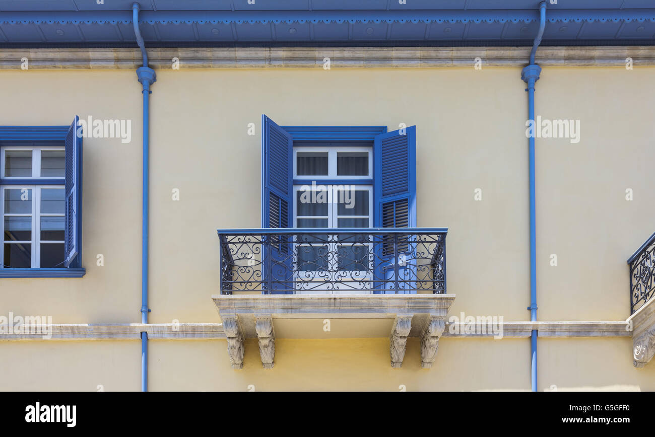 Te windows with opened blue shutters and balcony, Limassol, Cyprus ...