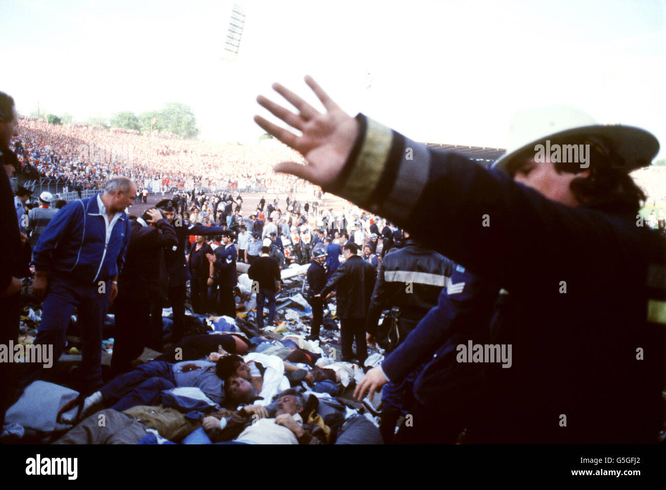 HEYSEL DISASTER. A FIRE OFFICER HOLDS BACK PHOTOGRAPHERS Stock Photo