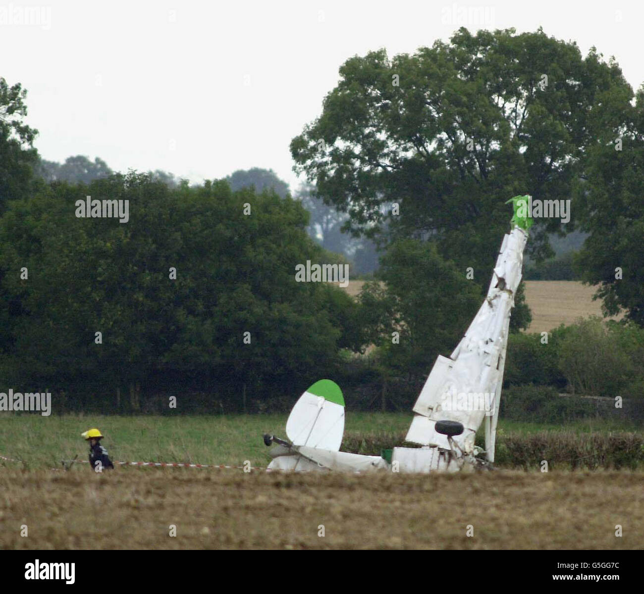 Police search the wreckage of a light aircraft in a field close to Aston Down Airfield near Stroud, Gloucestershire, which is thought to have collided with a glider. Two people were killed in the accident. * 15/9/01: Air accident investigators were examining wreckage after two people were killed in a mid-air collision between a glider and a light aircraft, Emergency services were called to Aston Down airfield, Aston Down, near Minchinhampton, Gloucestershire, yesterday after reports of the collision. A doctor pronounced two people dead, one from each aircraft, found in the wreckage of the Stock Photo