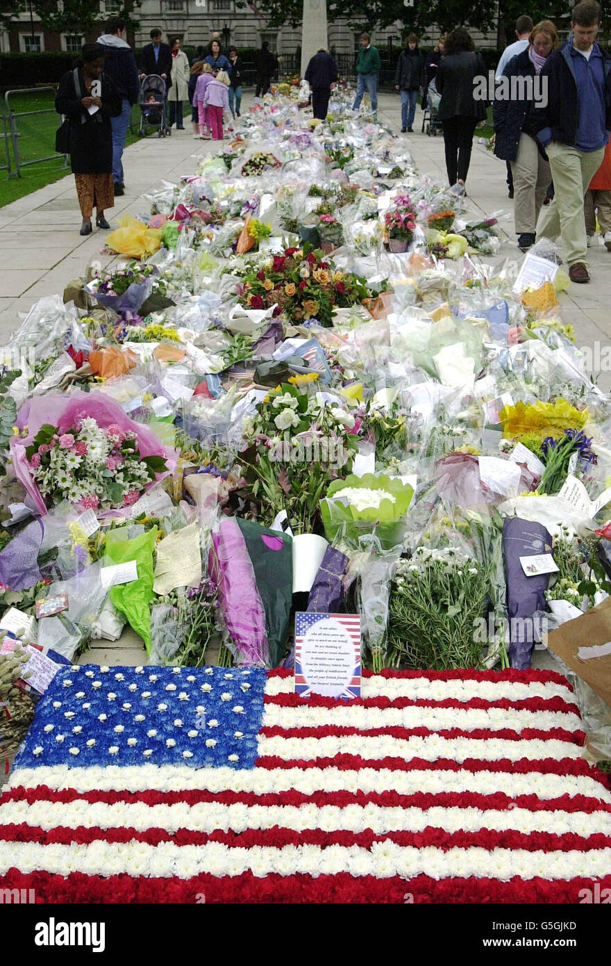 Numerous mourners continue to visit Grosvenor Square, central London, in front of the American Embassy, by the Franklin Roosevelt memorial which has become an area to place floral tributes to those who died in the attacks in the US. *This is the last day before the flowers, will be removed, the letters and gifts are to be archived. Stock Photo