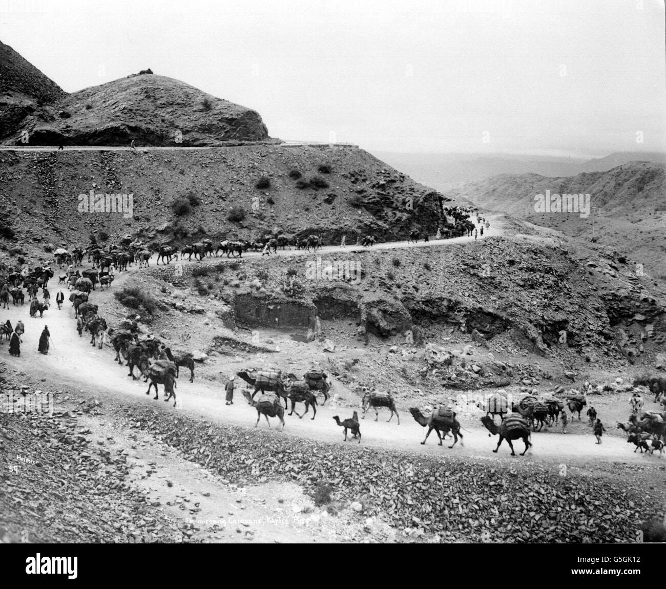 THE KHYBER PASS 1930: A camel train passes through the Khyber Pass on the frontier between Afghanistan and British India. Stock Photo