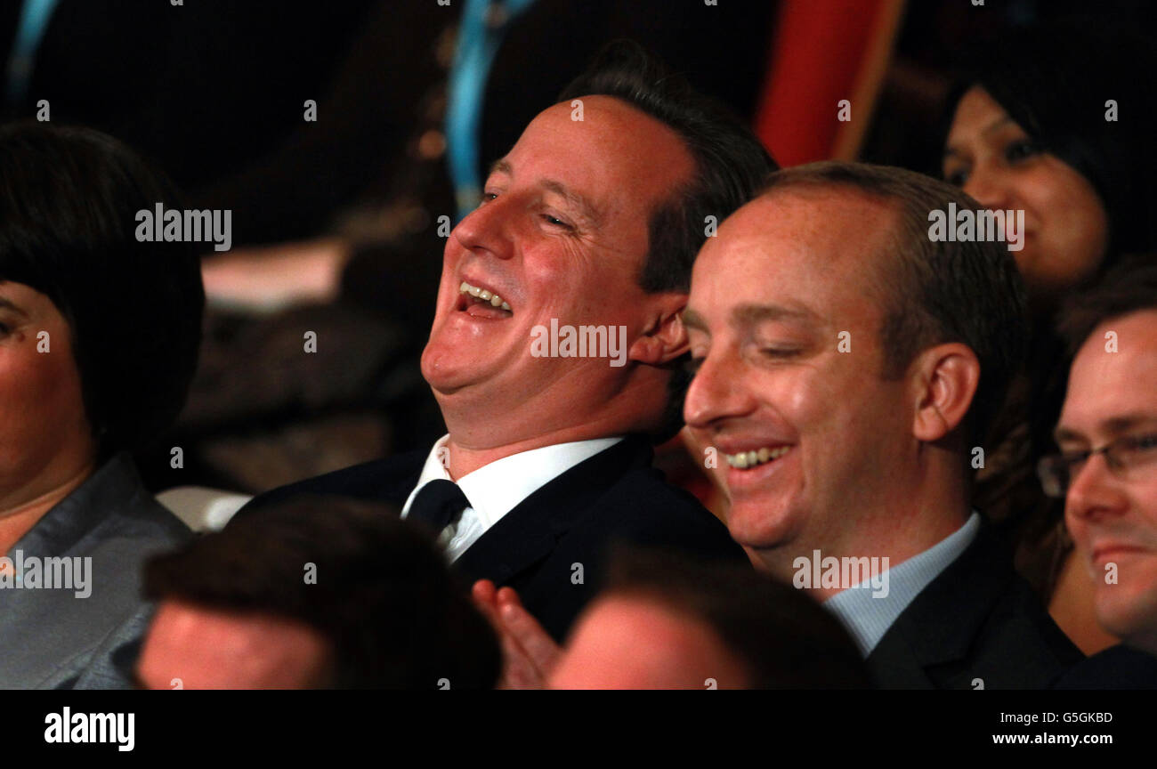 Prime Minister David Cameron laughs as Mayor of London Boris Johnson addresses the Conservative Party conference at the International Convention Centre in Birmingham. Stock Photo