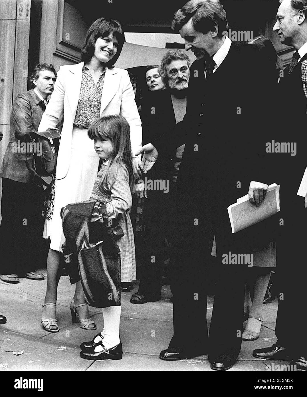 Actress Judy Loe (left), widow of actor Richard Beckinsale and their five year old daughter Katy, receive condolences from actor Richard Briers and other members of the acting profession, outside the Actors' Church, St. Paul's, Covent Garden after today's Memorial Service for Mr Beckinsale. Richard Beckinsale, boyish star of of TV's Porridge and Rising Damp, died on March 19th, aged 31. Stock Photo