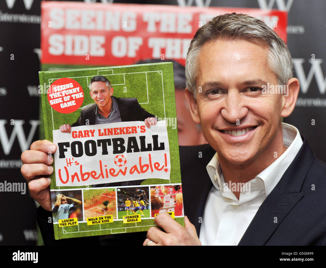 Gary Lineker, the former England striker now TV presenter with a copy of Unbelievable, which shows the funny, bizarre, and crazy World of football, before a book signing at Waterstones book shop
