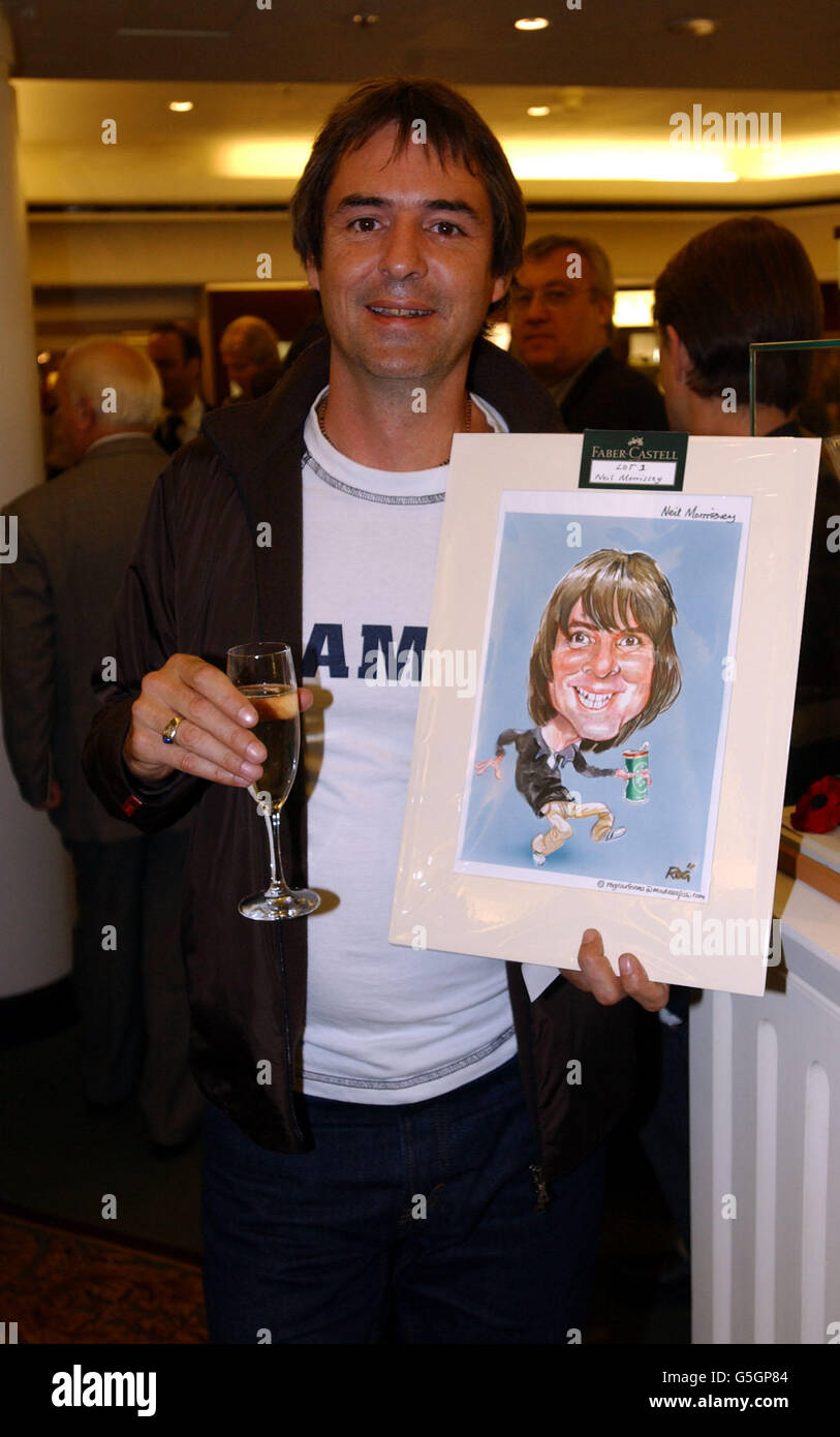 Actor Neil Morrissey with a drawing of himself during an auction of celebrity caricatures in aid of War Child following the launch of pen maker Faber-Castell's latest designs at Harrods in London. Stock Photo
