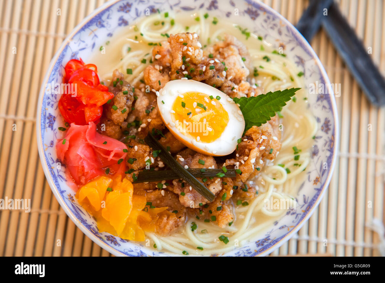 Chicken ramen topped with roast chicken, egg and pickles Stock Photo