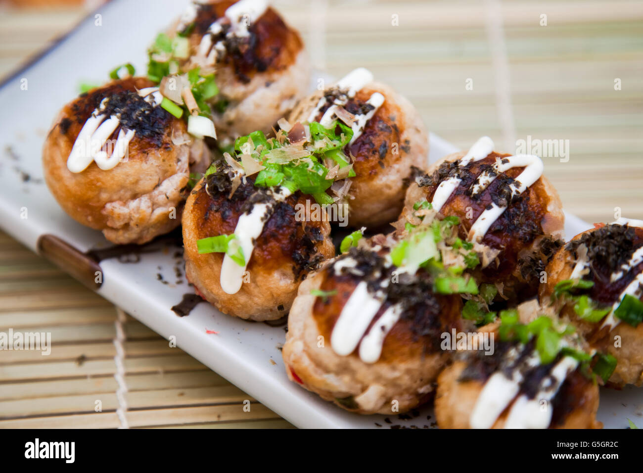 Takoyaki garnish with sauce, nori seaweed and spring onion Stock Photo