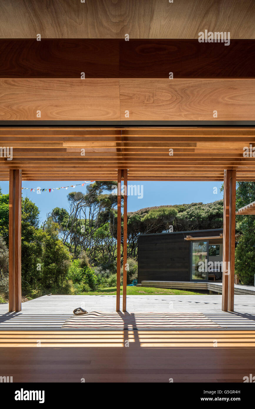 Living space, empty apart from artwork, wooden floor and ceiling with large open windows to outside. PEKA PEKA II HOUSE, Peka Peka - Kapiti Coast, New Zealand. Architect: HMA, 2016. Stock Photo