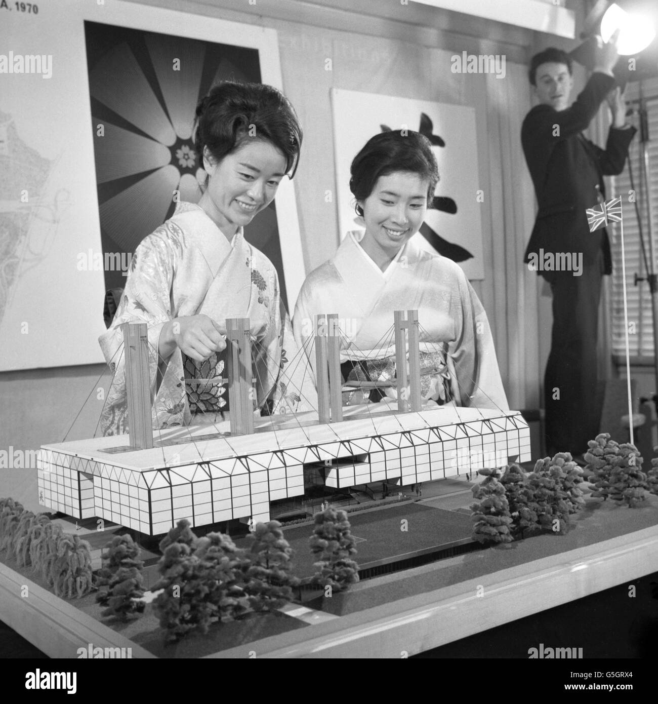 Kimono-clad Mrs M. Orita, left, and Mrs F. Nanami, from the Japanese Embassy in London, view a model of the British Pavilion for Japan's Expo '70 in Osaka. The model was on display at the Central Office of Information in London, which on behalf of the Foreign and Commonwealth Office, is responsible for the design, building, equipping and management of Britain's official display. Stock Photo