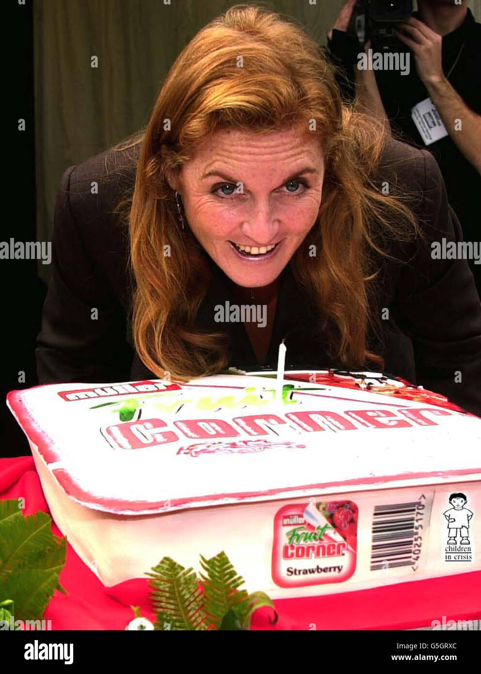 Sarah, the Duchess of York, Founder and Life President of the charity Children in Crisis blow out a candle on a cake after officially opening the Muller yogurt and dairy dessert company's 55 million factory extension in Market Drayton, Shropshire, on her 42nd Birthday. * Muller announced a formal link with the charity. Stock Photo
