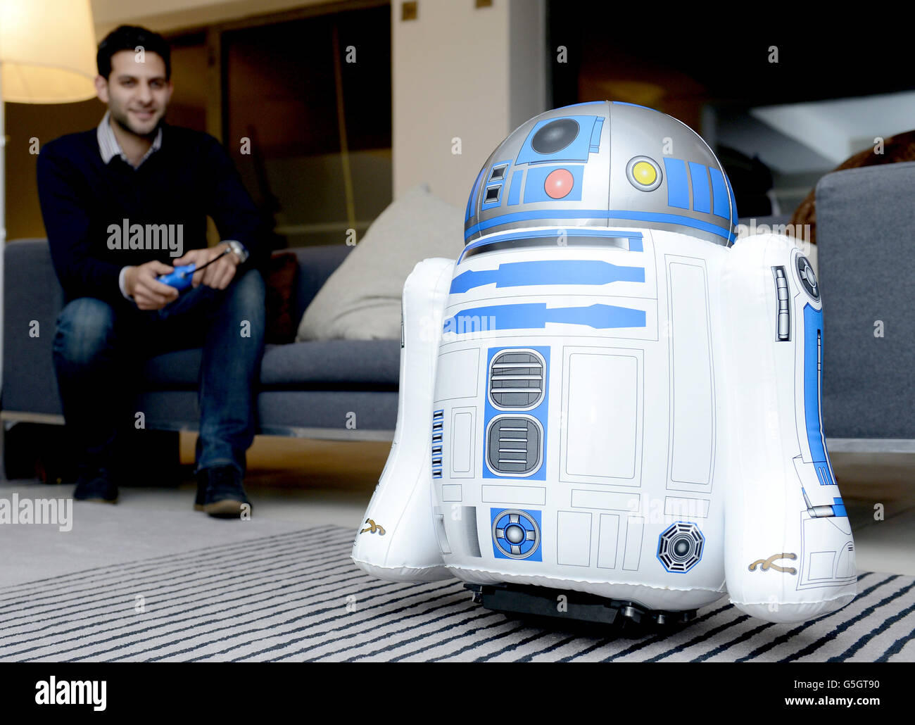 Daniel Abdelmassih of Bladez Toyz demonstrates a jumbo inflatable R2D2 at the Ultimate Men Kind House Party showcasing likely popular toys for Christmas. Stock Photo