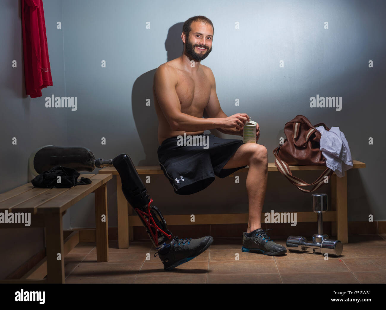 Man with a prosthesis in the gym locker room. Stock Photo