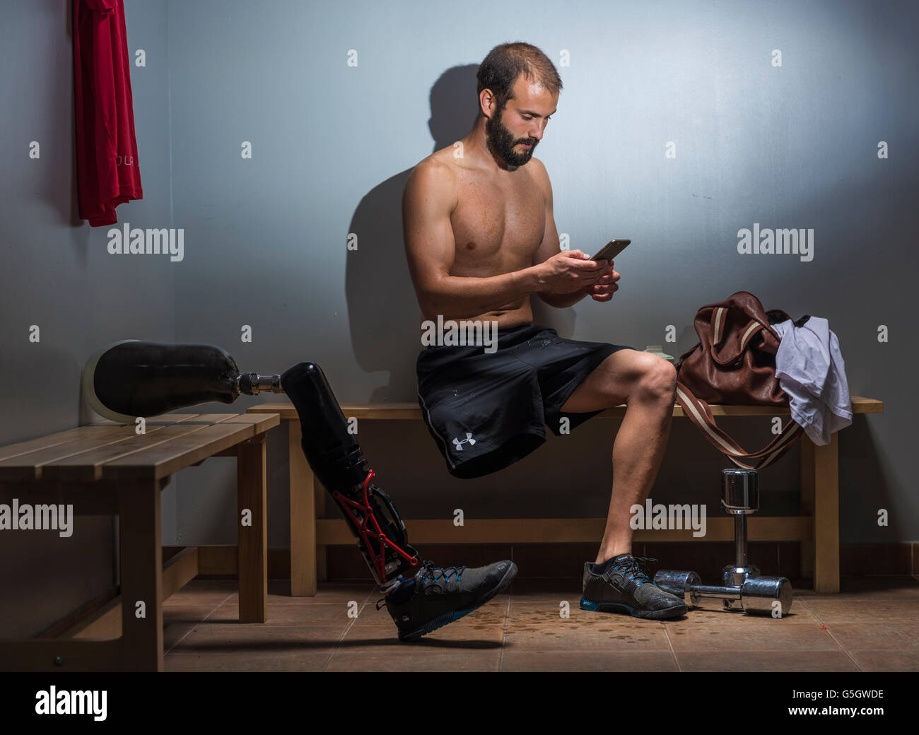 Man with a prosthesis in the gym locker room. Stock Photo