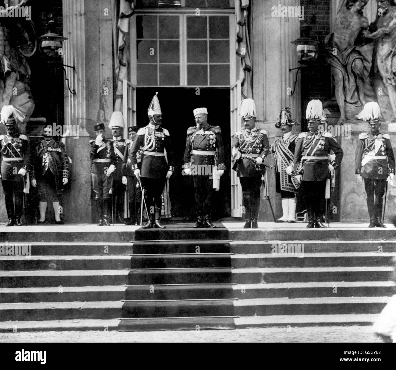 King Ferdinand of Bulgaria and Kaiser Wilhelm II stand side-by-side at a march past. The third and fifth figures from the left of the picture are the Crown Prince Boris and Prince Cyril of Bulgaria. Stock Photo