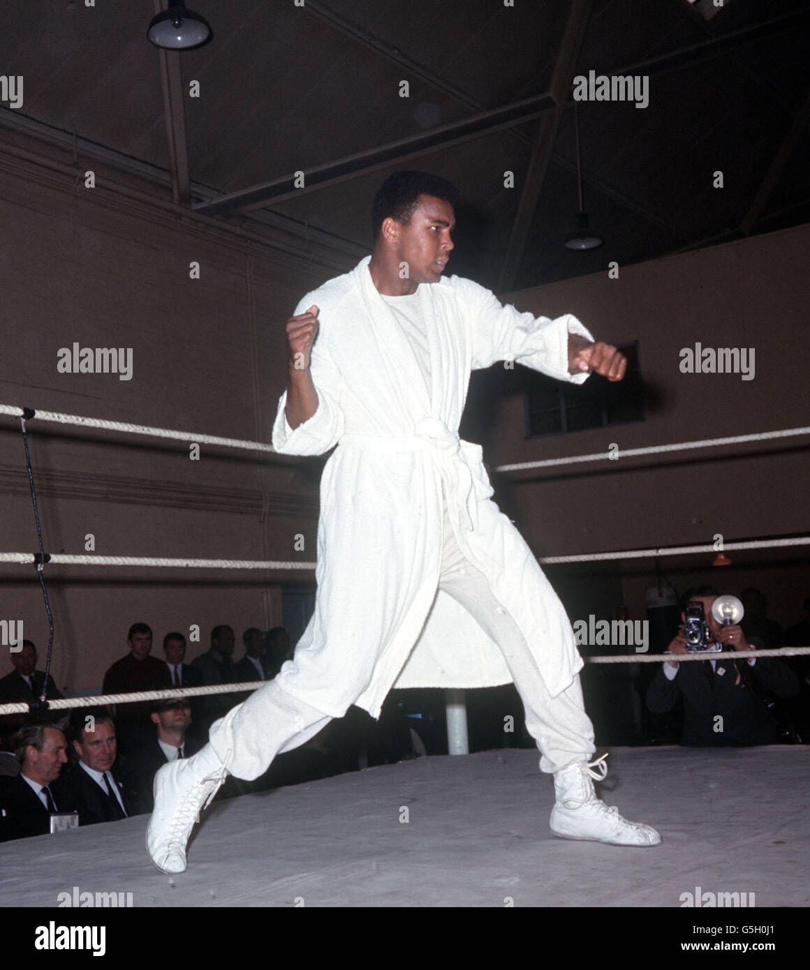 World heaveyweight champion Muhammad Ali ( Cassius Clay ) shadow boxing in the ring during training at the White City drill hall, London, for the defence of his title against Henry Cooper. 17/01/02: Ali celebrates his 60th birthday. Stock Photo