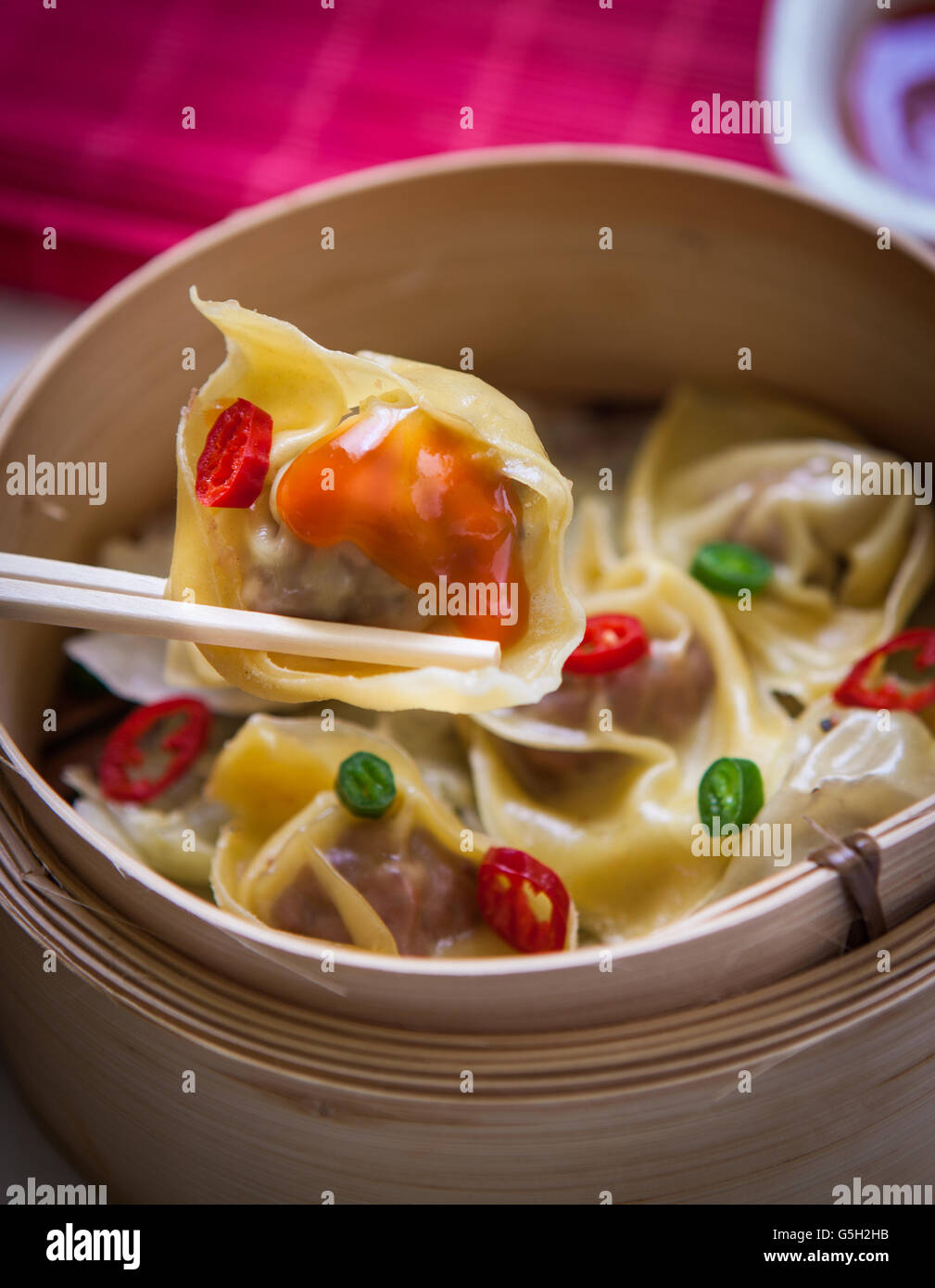 Steamed chinese dimsum on steamer with sweet and sour sauce Stock Photo