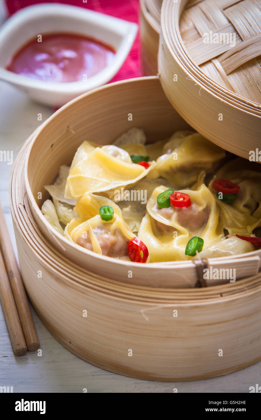 Steamed chinese dimsum on steamer with sweet and sour sauce Stock Photo