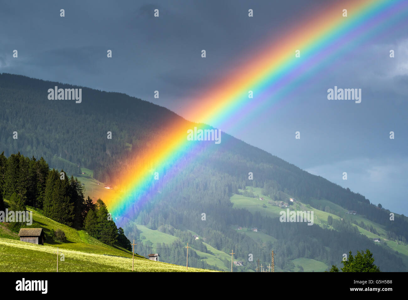 Mountain landscape with rainbow in Val Pusteria or Pustertal valley, South Tyrol, Italy Stock Photo